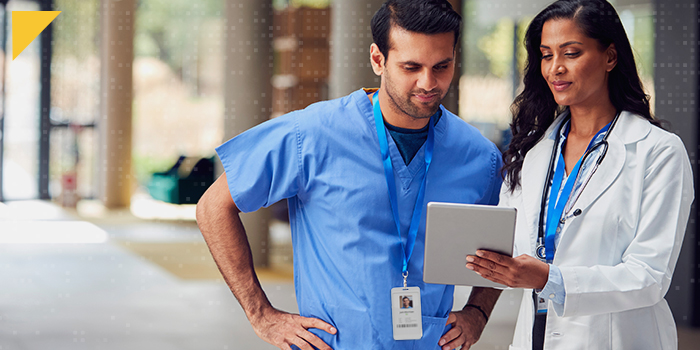 Two doctors review information on a tablet together