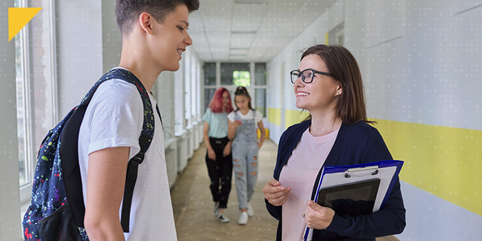 High school students interacting in hallway