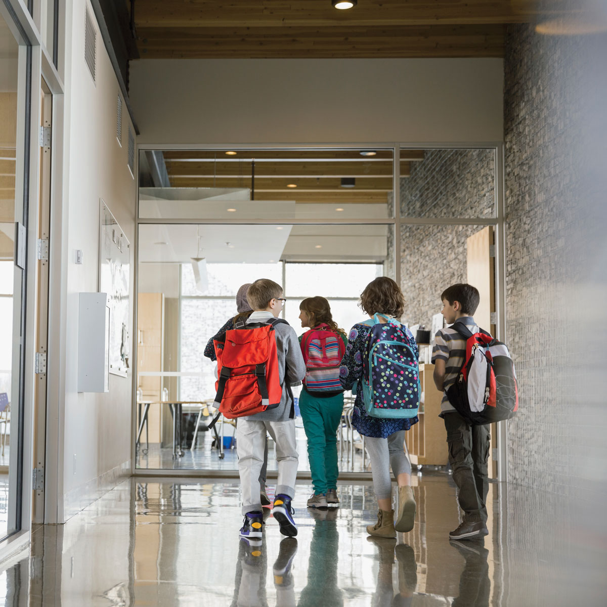 kids walking through hallway in school
