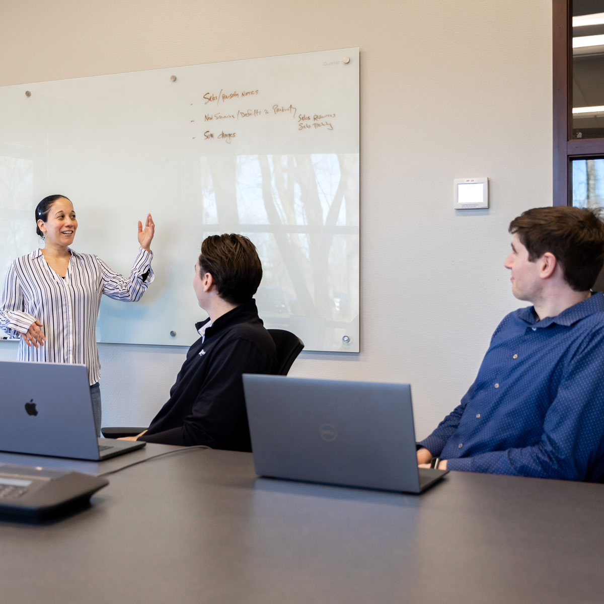 Singlewire employee presenting to coworkers