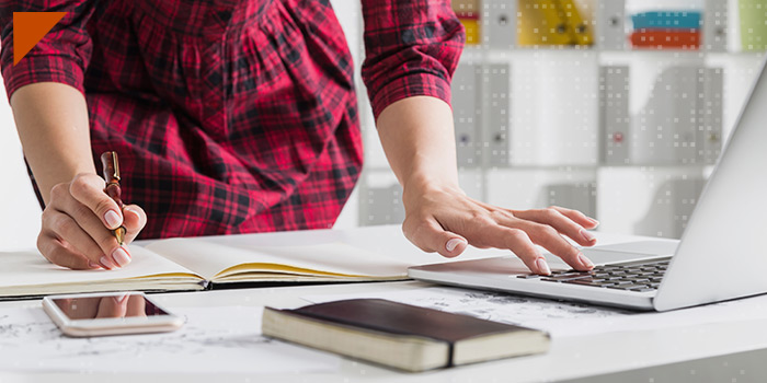 person working on notebook and laptop