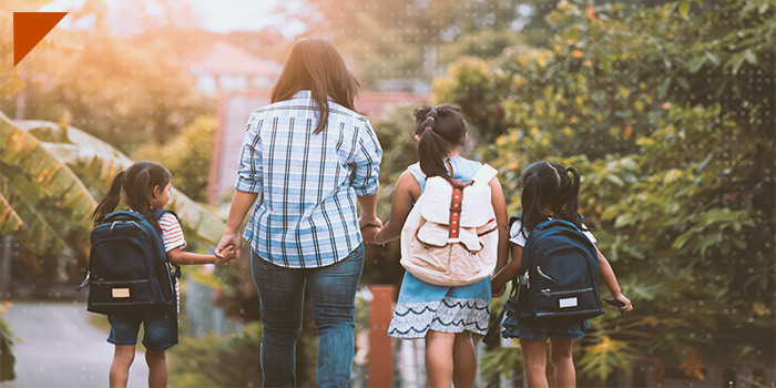 elementary students walking with their mother