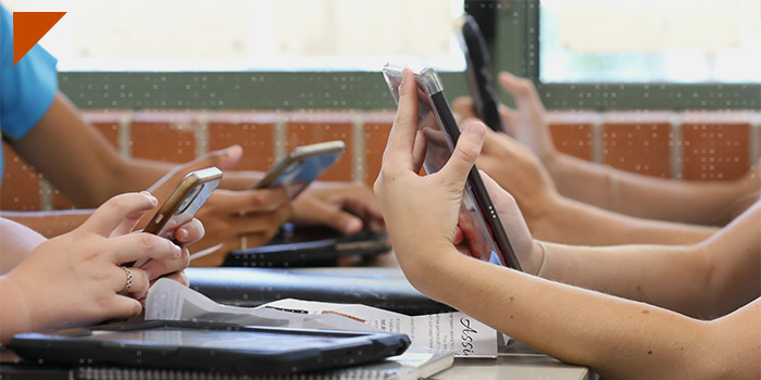 Children's hands using cell phones